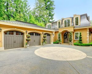 A luxury home with two garages and a circular driveway.
