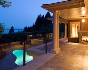 A beachfront patio with a fire pit and a view of the ocean.